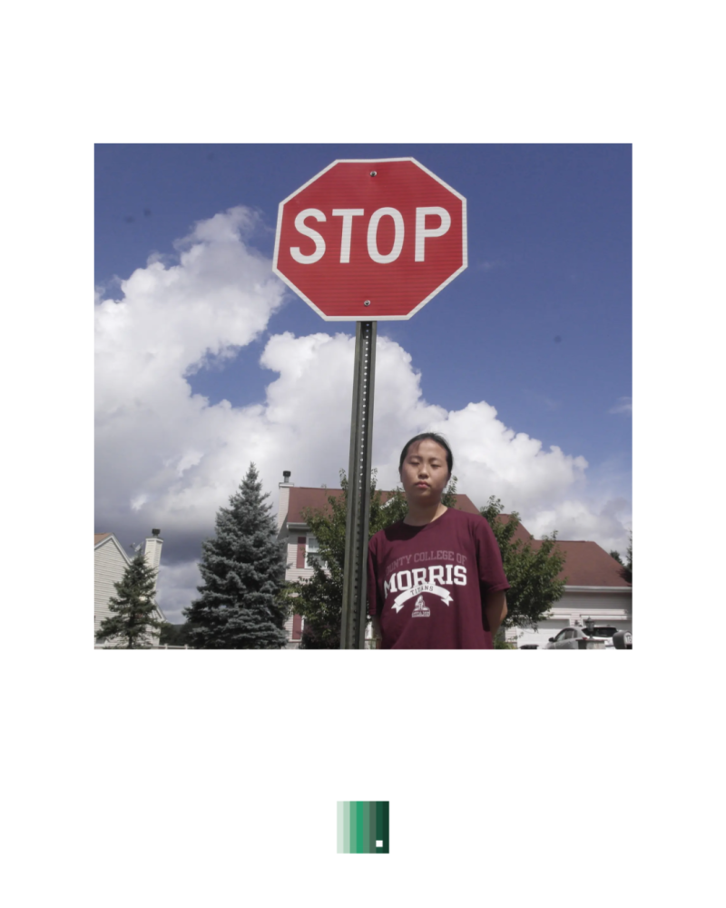 A stop sign against a cloudy blue sky